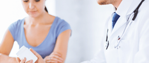 A doctor discussing prescription drugs with a patient.