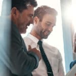 Three people discussing a PBM report together.