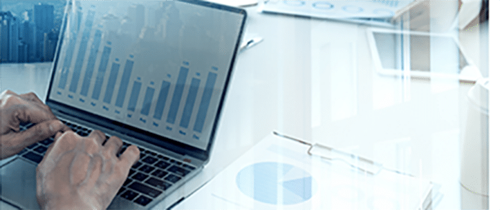 A man using drug pricing analysis on his computer.