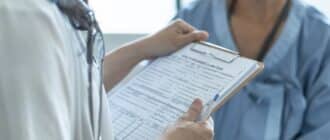 closeup of healthcare employee holding an insurance claim form
