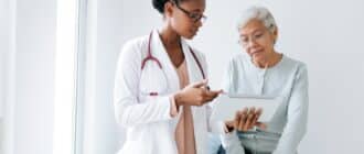 female doctor consulting elderly female patient