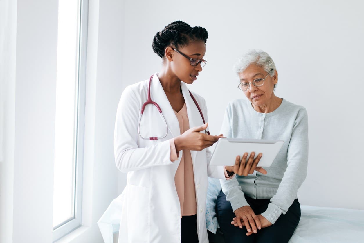 female doctor consulting elderly female patient