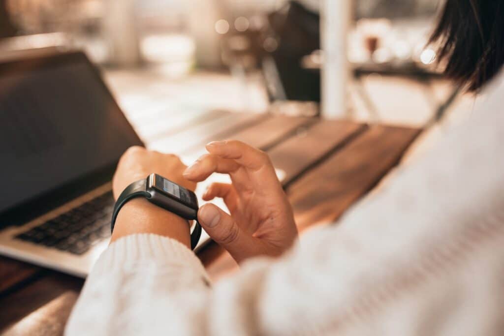 close up of person looking at smart watch on their wrist