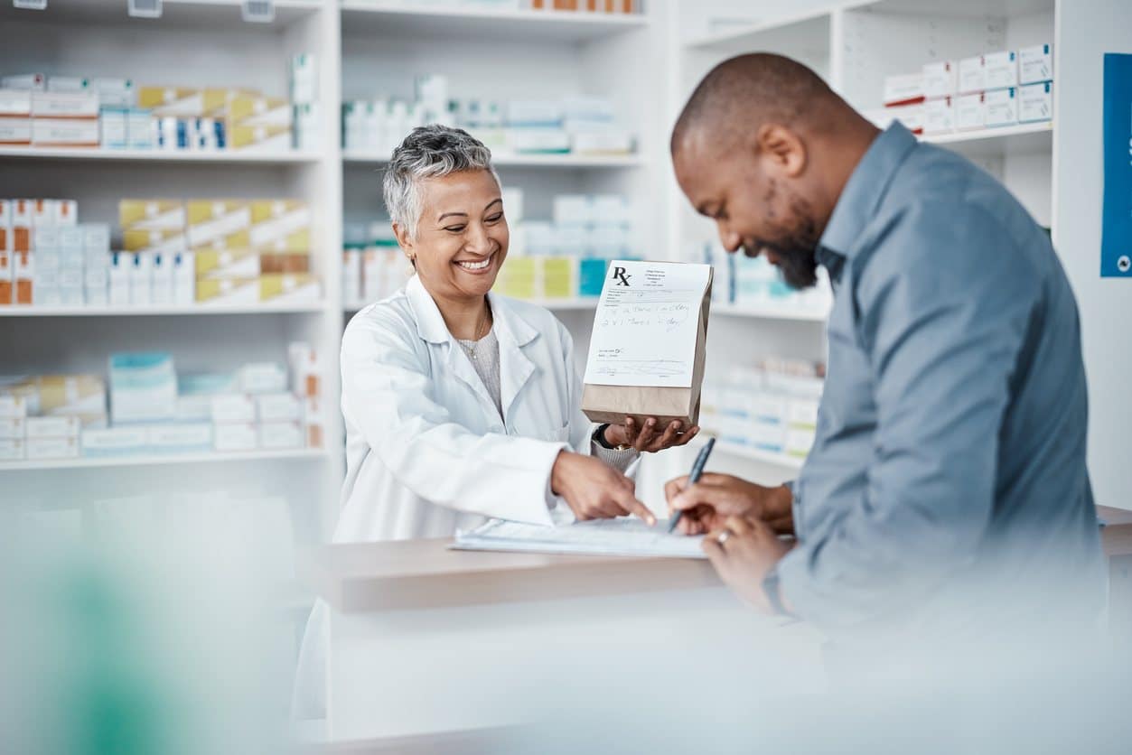 pharmacist and customer buying prescription